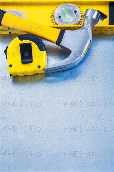 Construction level band line claw hammer on metallic background maintenance concept