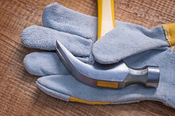 Claw hammer on glove close-up