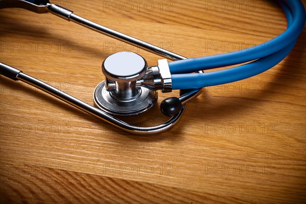 Close-up of classic stethoscope on wooden board medical concept