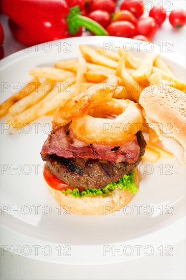 Classic american hamburger sandwich with onion rings and french fries