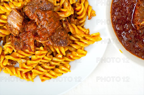 Fusilli pasta al dente with neapolitan style ragu meat sauce very different from bolognese style