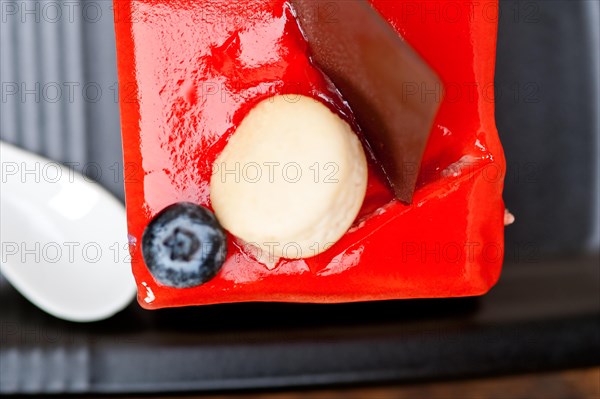 Fresh strawberry yogurt mousse with macaroon and blueberry on top