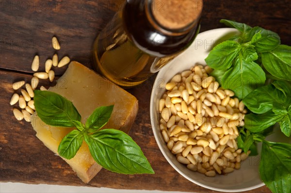 Italian basil pesto ingredients over old wood macro