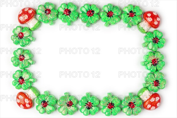 A frame of shamrocks with ladybirds and toadstools