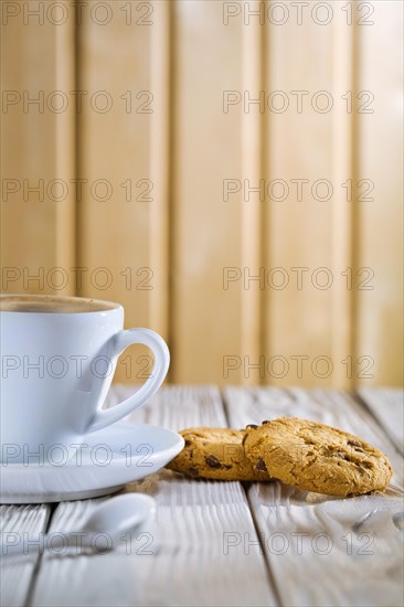Coffee cup and cookies on old white table