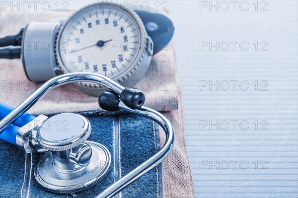 Blood pressure monitor and stethoscope on blue background medical concept