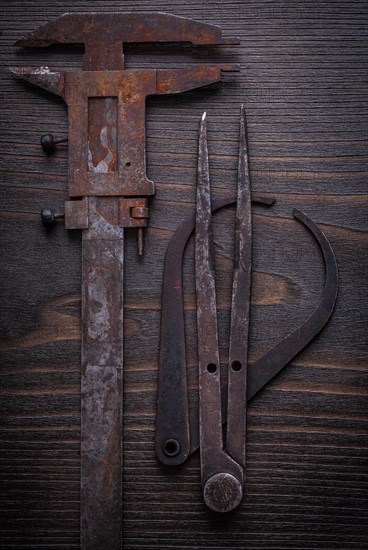 Composition of old-fashioned vernier scales on vintage wooden board