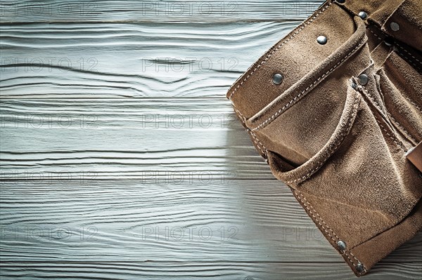 Leather toolbelt on white board copy space