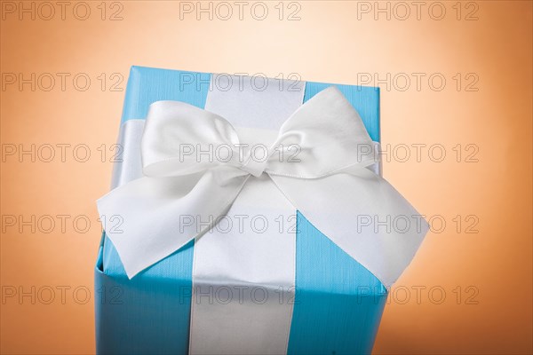 Blue gift box on a light brown background