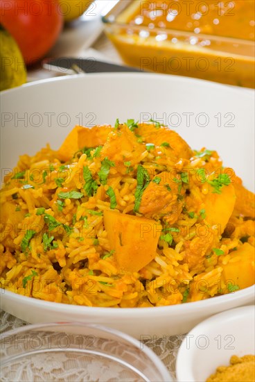 Fresh home made curry beef rice and potatoes with ingredients around composition