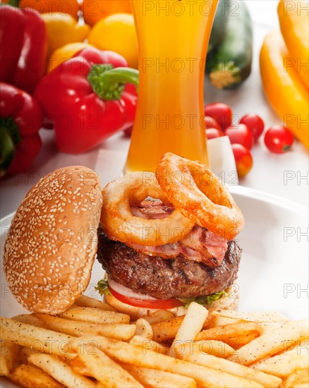 Classic american hamburger sandwich with onion rings and french fries