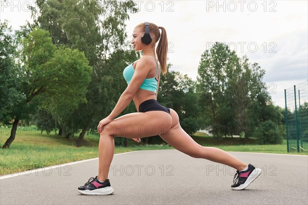 Charming girl does a workout in the park. The concept of a healthy lifestyle. Sports Equipment. Fitness style advertisement. Mixed media