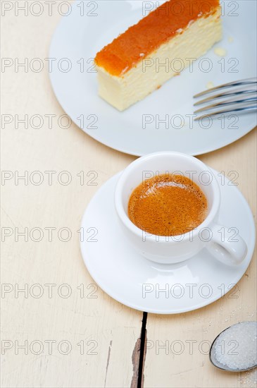 Italian espresso coffee and cheese cake over white wood table