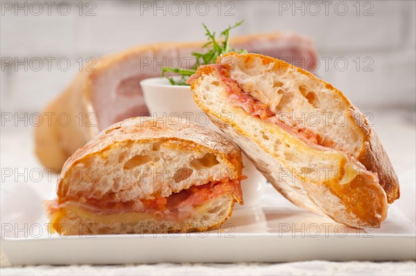 Italian ciabatta panini sandwich with parma ham and tomato