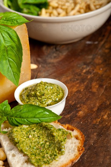 Italian basil pesto bruschetta ingredients over old wood macro