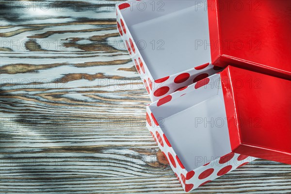Red opened present boxes on wooden background