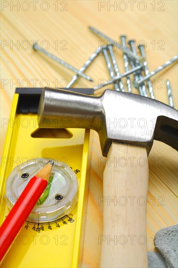Hammer and spirit level with pencil nails