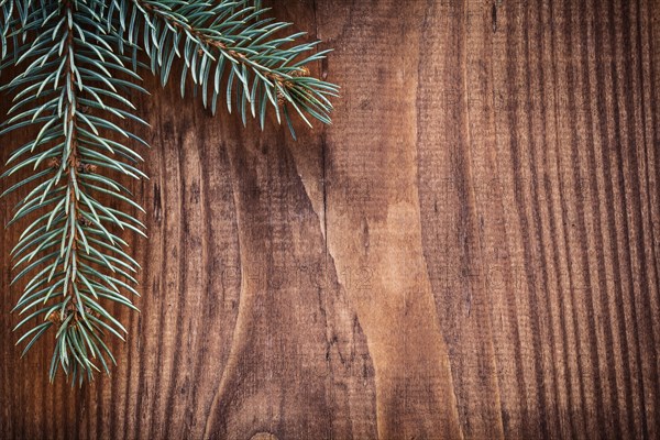 Copyspace Christmas background branches of fir tree on old wooden board horizontal version