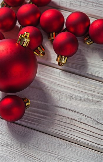 Copyspace image red Christmas baubles on old painted white wooden panels