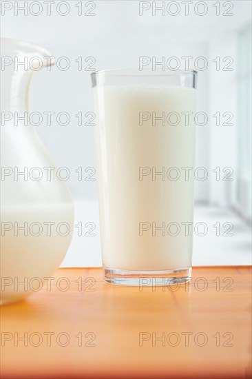 Glass of milk and jug on the table