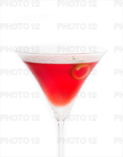 Cosmopolitan drink cocktail straight up on martini cup with lime peel isolated on white background