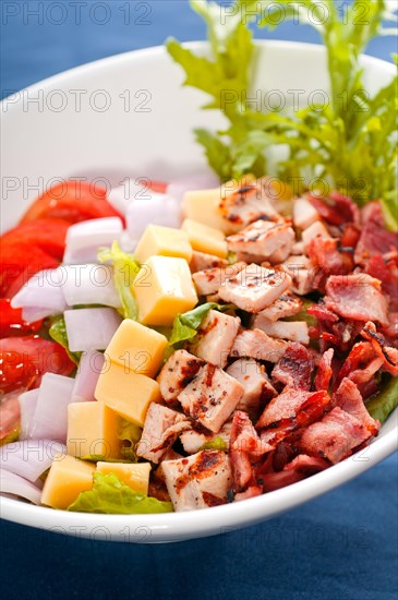 Fresh classic caesar salad over blue tablecloth close up