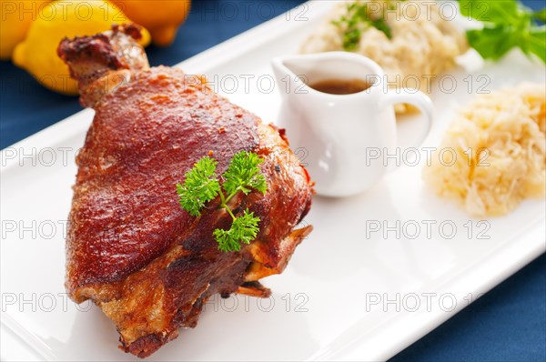 Original German BBQ pork knuckle served with mashed potatoes and sauerkraut