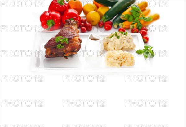 Original German BBQ pork knuckle served with mashed potatoes and sauerkraut