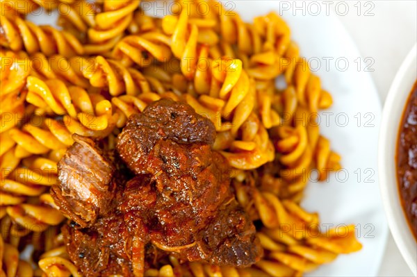 Fusilli pasta al dente with neapolitan style ragu meat sauce very different from bolognese style