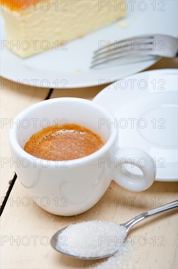 Italian espresso coffee and cheese cake over white wood table