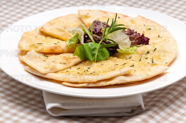 Fresh healthy garlic pita bread pizza with salad on top