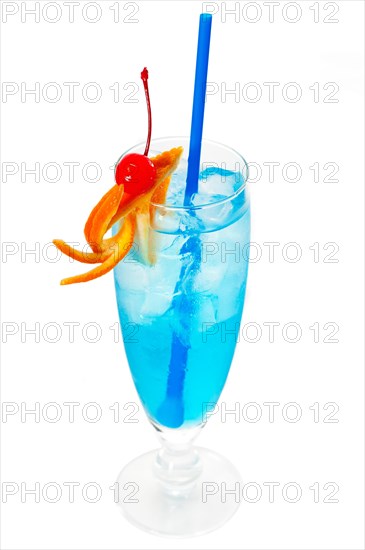 Blue long drink cocktail with orange and cherry garnish and blue straw