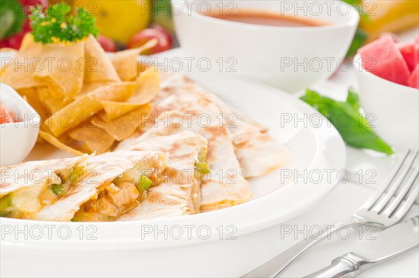 Original Mexican quesadilla de pollo with nachos served with gazpacho soup and watermelon