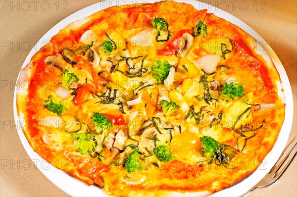 Fresh italian thin style vegetarian pizza with fresh mixed vegetables close up