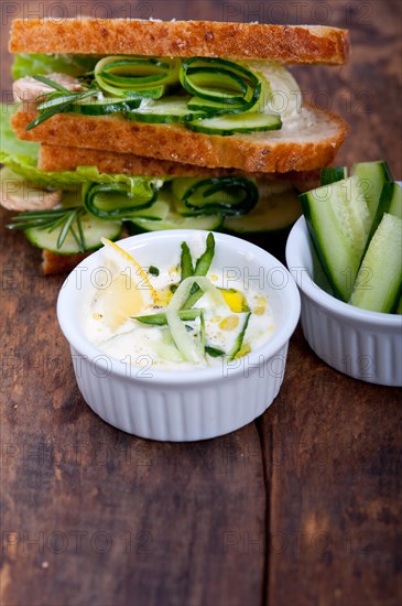 Fresh vegetarian sandwich with garlic cheese dip salad on rustic table