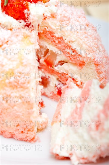 Fresh pink strawberry and whipped cream dessert macro close up