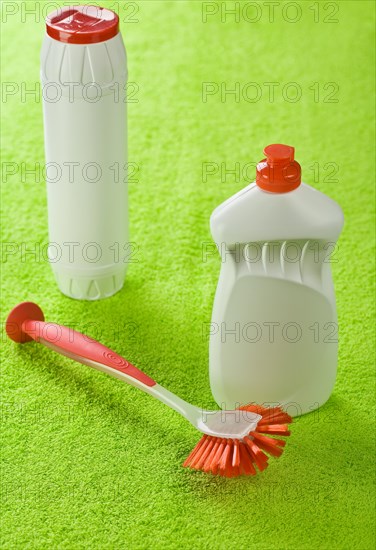 Bottles and brushes on a green towel