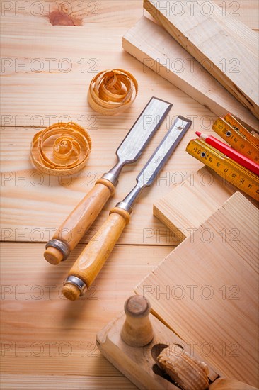 Carpenter's chisel and other tools on wooden panels Construction concept