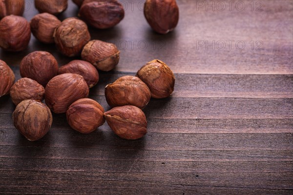 Organised copyspace hazelnuts on vintage wooden board