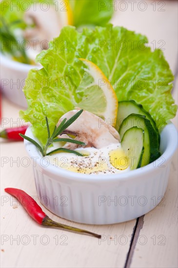 Fresh organic garlic cheese dip salad on a rustic table