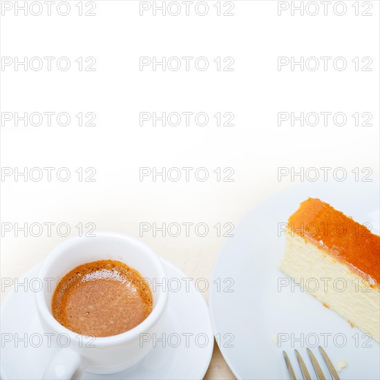 Italian espresso coffee and cheese cake over white wood table