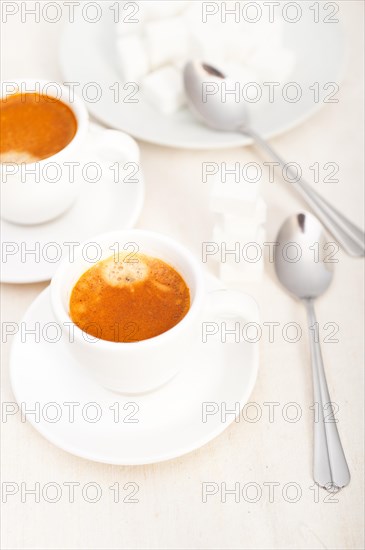 Italian espresso coffee fresh brewed macro closeup with sugar cubes