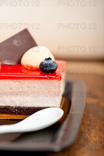 Fresh strawberry yogurt mousse with macaroon and blueberry on top