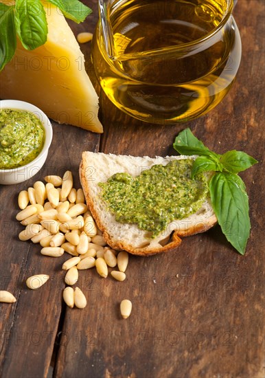 Italian basil pesto bruschetta ingredients over old wood macro