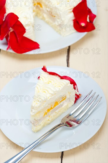 Whipped cream mango cake with red rose petals