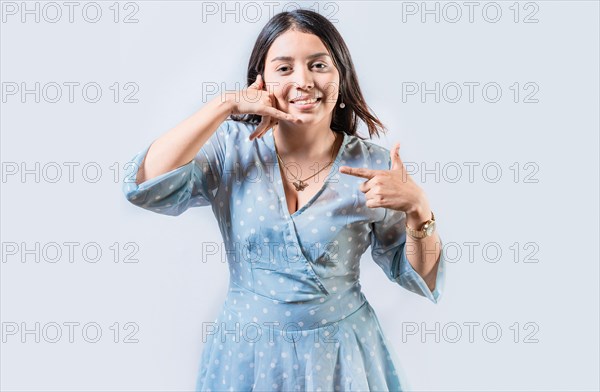 Young woman gesturing CALL ME in sign language isolated. Manual gestures of people with hearing problems