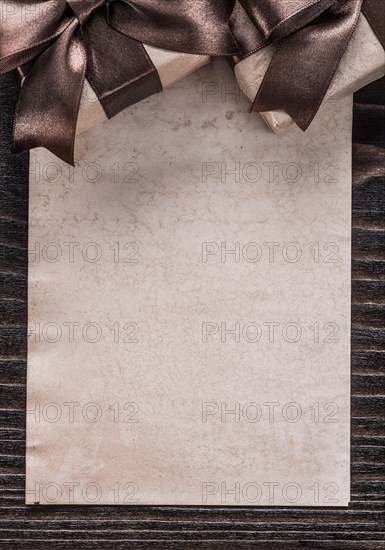 Gift containers with tied ribbons paper vertical view holiday concept