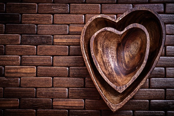 Heartshaped bowls on wooden place mat food and drink concept