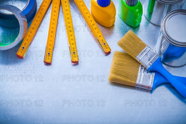 Group of coloured objects with adhesive tapes and wooden counters on a metallic background Design concept