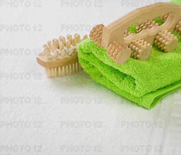 Brush and massager with green towel